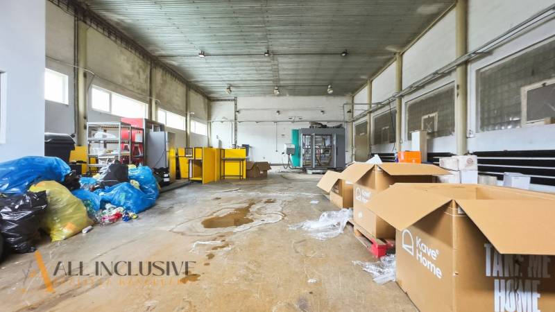 A large storage room with boxes and garbage bags in commercial premises.