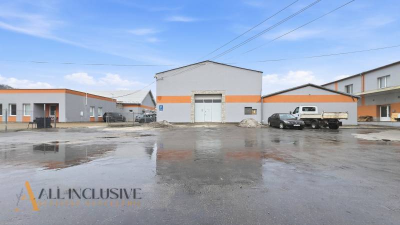 The exterior of commercial premises on Pod kalváriou Street in Topoľčany with parked cars.