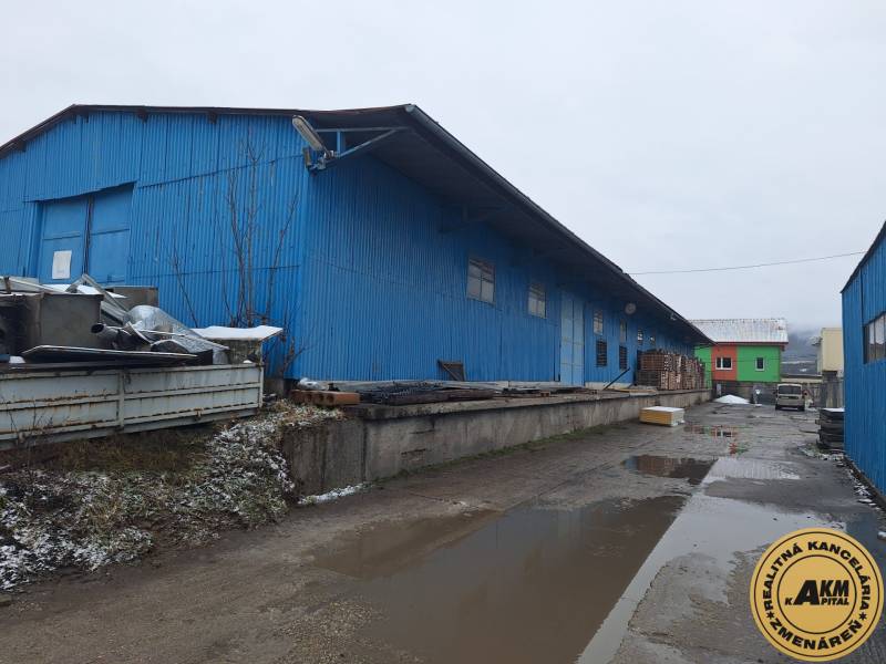 Blue warehouse buildings on Lieskovská Road in Zvolen, surrounded by various materials.