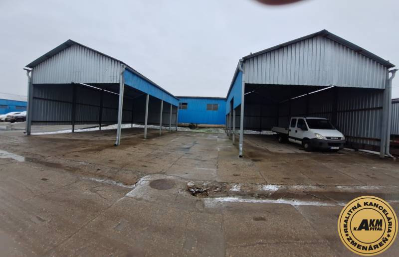Warehouses and halls with parked vehicles on Lieskovská Road in Zvolen.