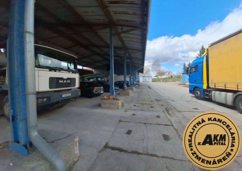 On Lieskovská cesta street, warehouses and halls with trucks parked under the roof.