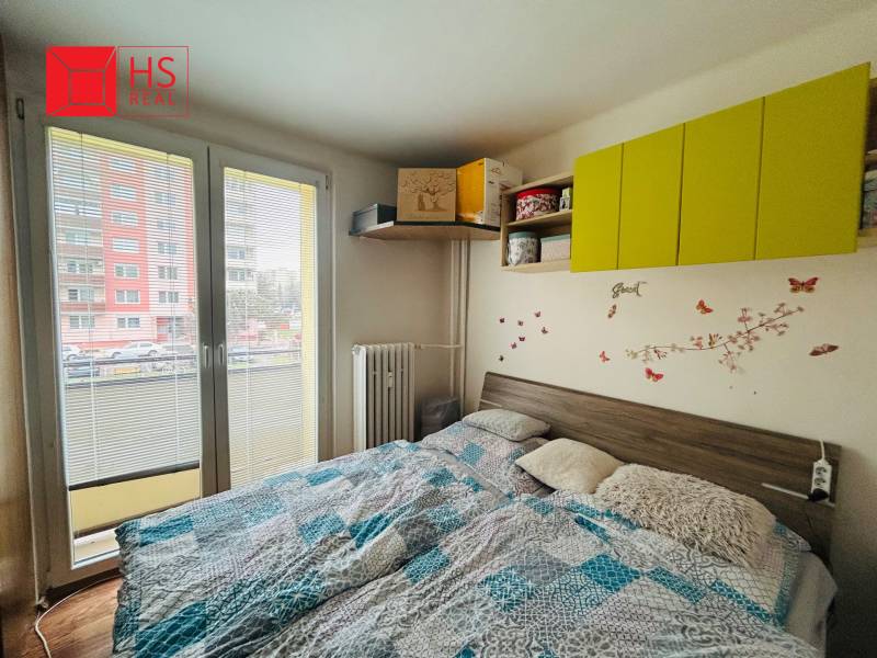 Bedroom with wall decorations in a 3-room apartment, floor with wood decor.
