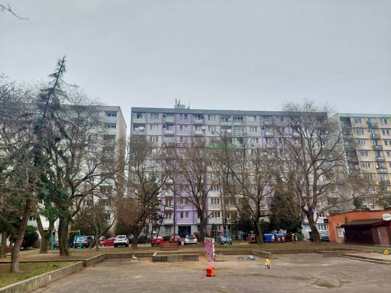 Apartment building on Šalviova Street in Bratislava-Ružinov with a children's playground and parked cars.