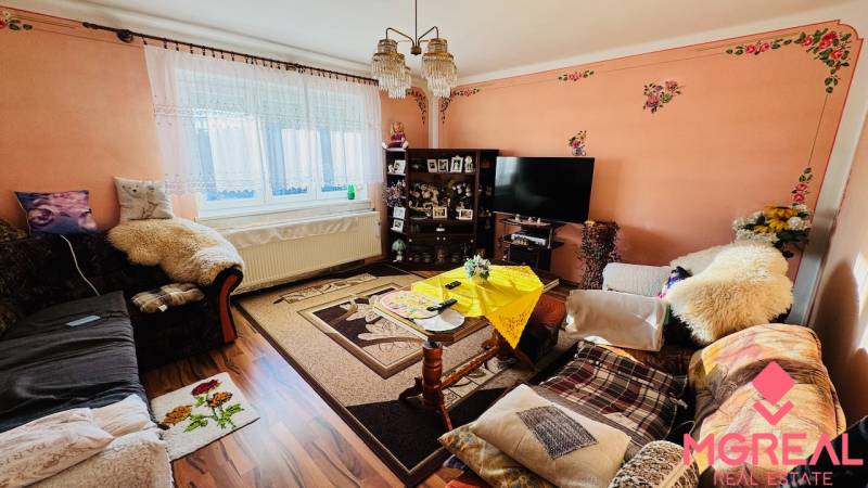 Living room in a family house with floral decorations and wooden decor flooring.
