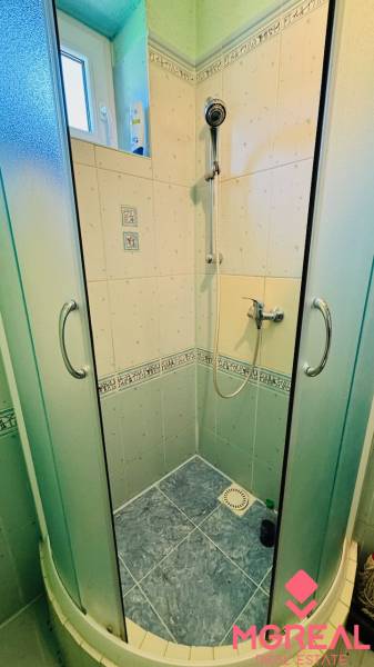 Shower corner with ceramic tiles in a family house.