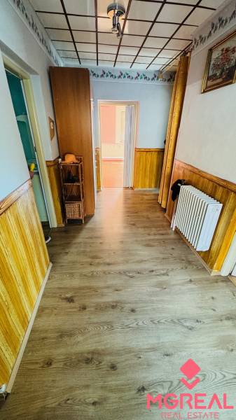 Interior of a family house with a wooden decor floor and wooden wall paneling.