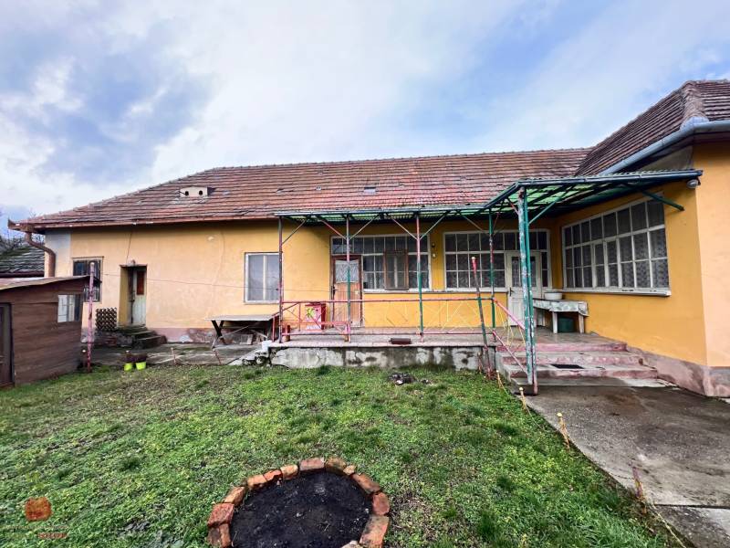 A family house in Komjatice with a garden, terrace, and wooden shelter.