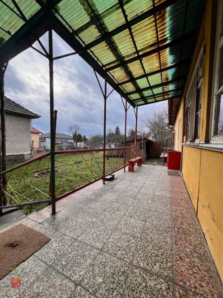 A family house in Komjatice with a terrace and a view of the garden.