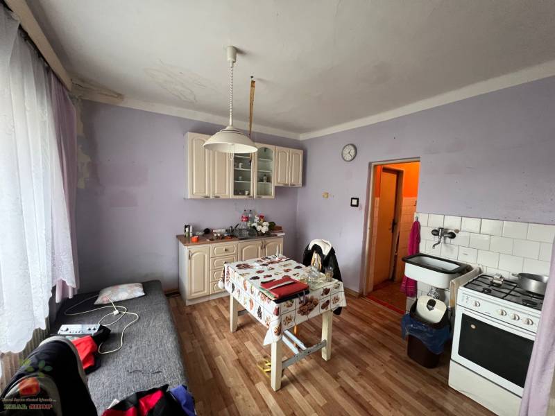A kitchen in a family house with a wooden decor floor and furniture.