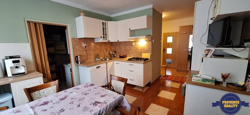 Kitchen in a 3-room apartment with a kitchen unit, hob, and coffee maker.