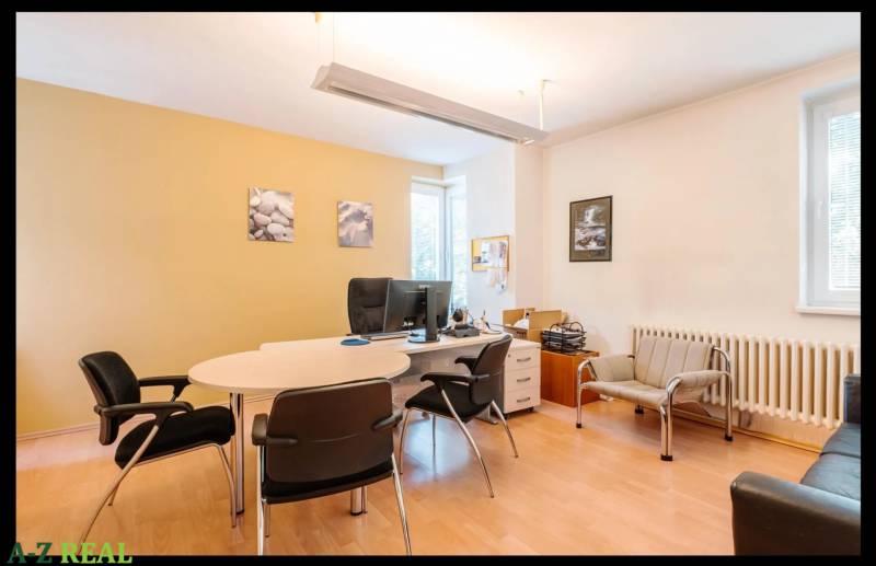 An office with furniture and flooring featuring wood decor in a family house.