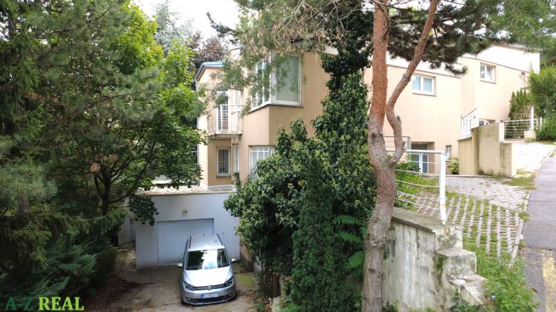 A family house on Malinová Street in Bratislava - Staré Mesto surrounded by greenery and trees.