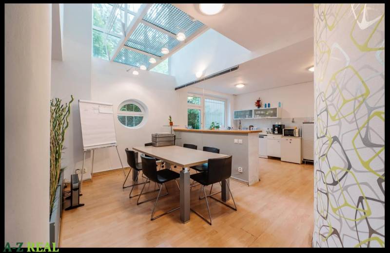 Interior of a family house with a dining table, round window, and floor with wood decor.