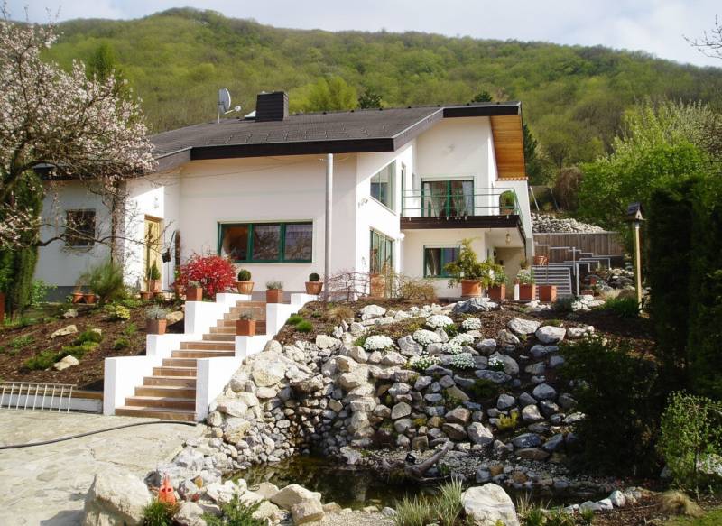 A family house in Hainburg an der Donau with a well-maintained garden and stone landscaping.