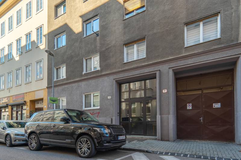 The exterior of the building on Heydukova Street in Bratislava with parked cars.