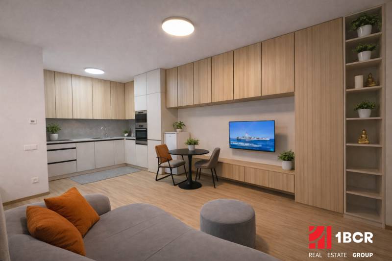 Living room with a kitchenette, wooden decor flooring, sofa, and dining table.