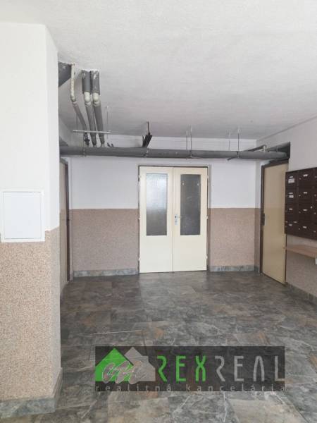 The entrance hall of the apartment building on Venevská Street in Veľký Krtíš with mailboxes.