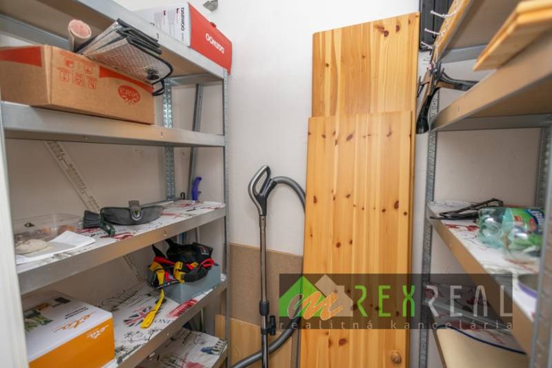 Storage space with metal shelves and various items in a 3-room apartment.