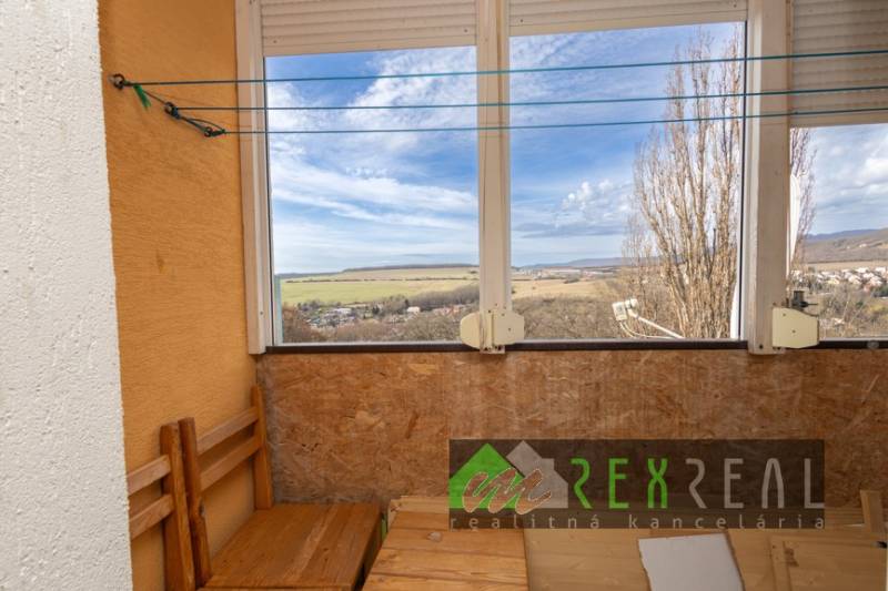 A glazed loggia of a 3-room apartment with a view of the surroundings of Veľký Krtíš on Venevská Street.