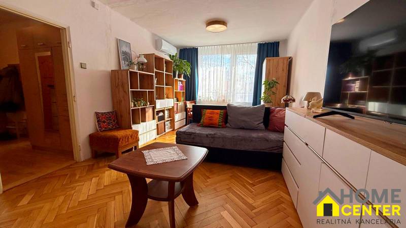 Living room in a 3-room apartment with a sofa and furniture, floor with wood decor.