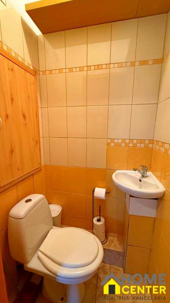 Bathroom with a toilet and a sink in a 3-room apartment.
