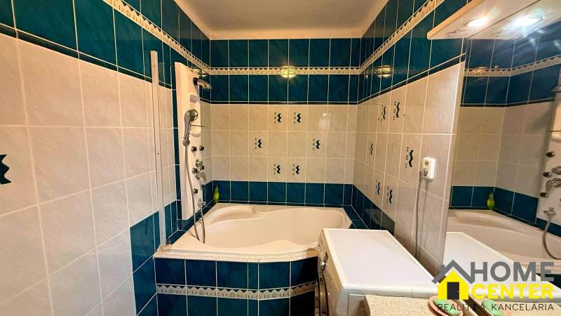 A bathroom in a 3-room apartment with a bathtub, tiles in a blue and white color scheme.