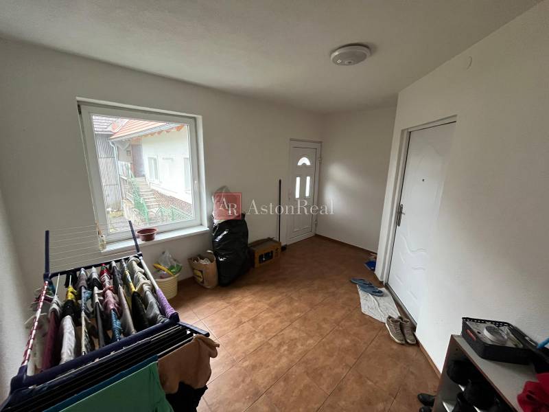 The entrance hall in the family house with a wooden decor floor adjoins the vestibule.