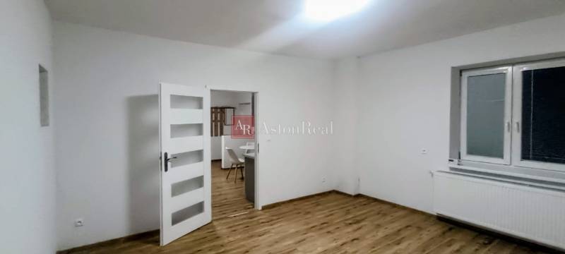 Interior of a family house with white walls and a floor with a wood decor.