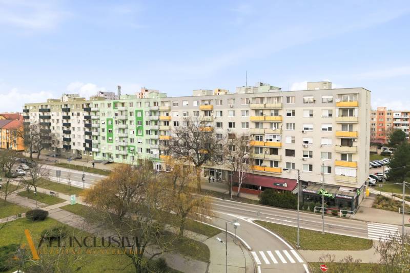 Apartment buildings on Hlavná Street in Galanta surrounded by greenery and road infrastructure.