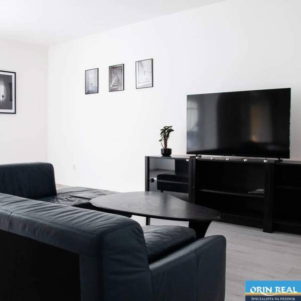 Living room with a corner sofa and a television in a 2-room apartment.