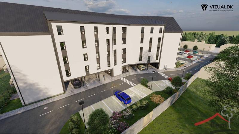 Commercial land on Moravská Street in Vráble with a parking lot and a modern building.