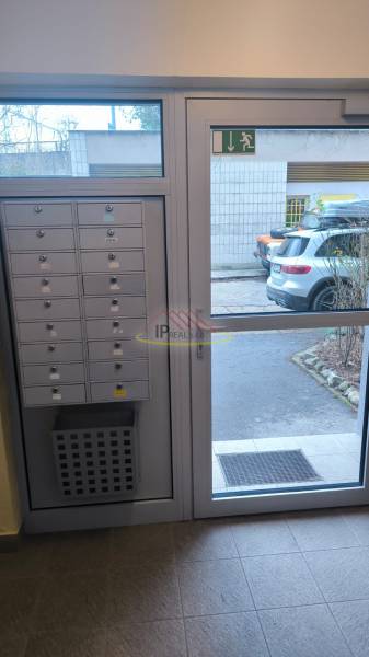 Tiled floor decor, mailboxes, and doors in an apartment building on Janotova Street in Bratislava.