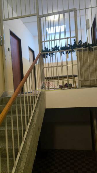 Interior of an apartment building with ornate railings and access stairs, 4-room apartment.