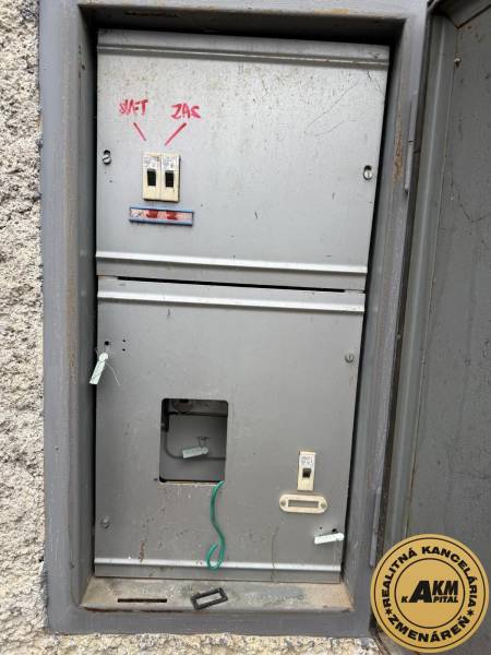 An old electrical cabinet with circuit breakers on Prachatická Street in Zvolen near the garages.