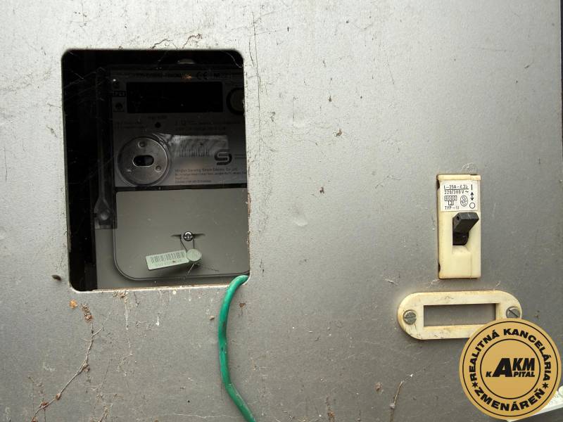 Electric meter and circuit breaker on the wall in the garages.