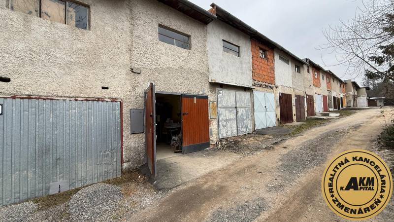 Garages on Prachatická Street in Zvolen with various types of doors and facades.