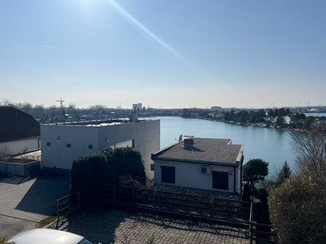 View from the cottage at Sunny Lakes in Senec, with a calm water surface.