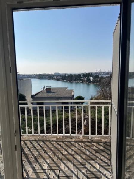 View from the cottage at Sunny Lakes in Senec with wooden floor decor.