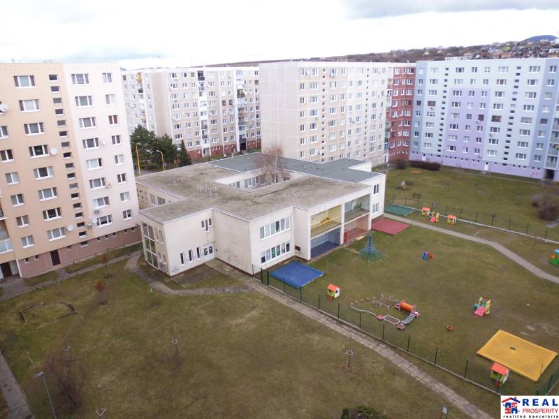 Buildings and a playground on Čergovská Street in Prešov, between the apartment buildings.