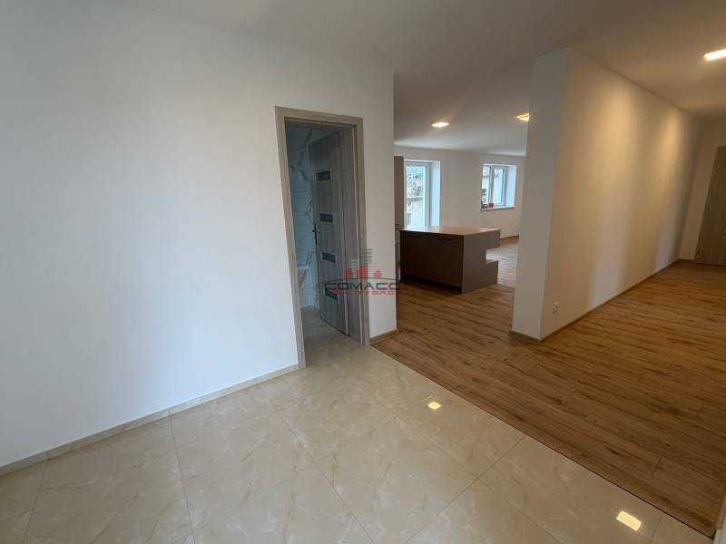 Interior of a family house with a wooden decor floor and light walls.