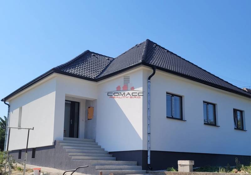 Family house in Sasinkovo on Sasinkovo Street with a dark roof and staircase.