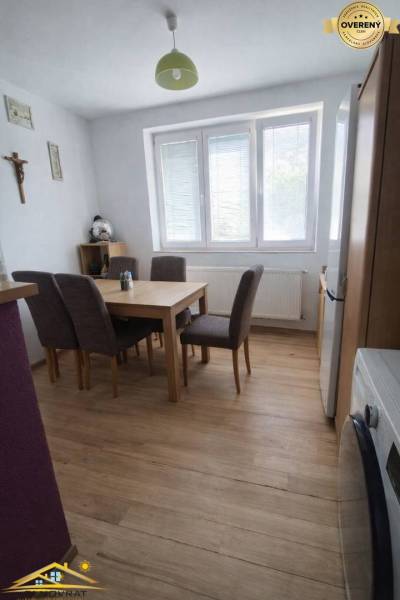 Dining room in a family house with a wooden decor floor and a dining table.