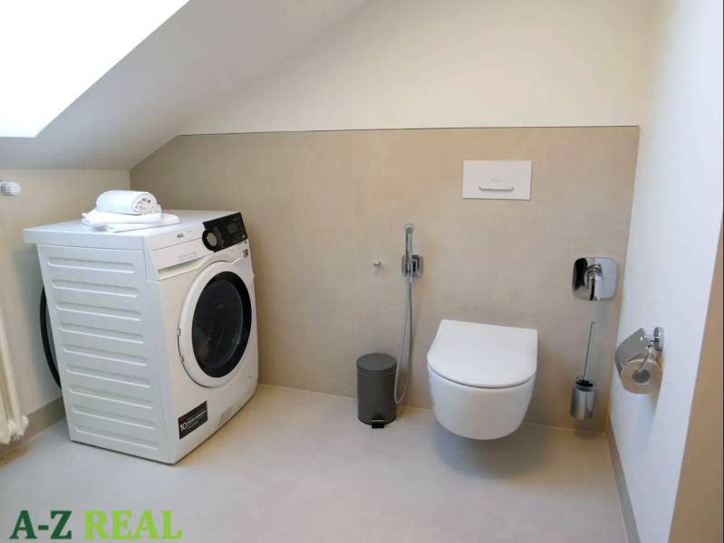 Bathroom in a 3-room apartment with a built-in washing machine and toilet.