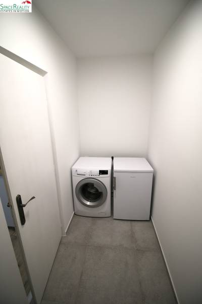 Washing machine and refrigerator on light tiles in a 3-room apartment.