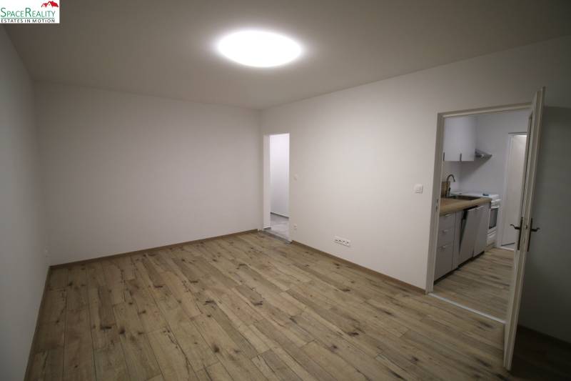 Living room connected to the kitchen, floor with wood decor, 3-room apartment.