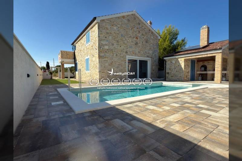 Family house in Vrsi with stone cladding and a pool on the terrace on Vrsi street.