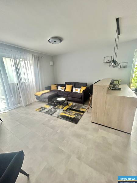 Living room with a sofa, table, and light-colored walls in a two-room apartment.