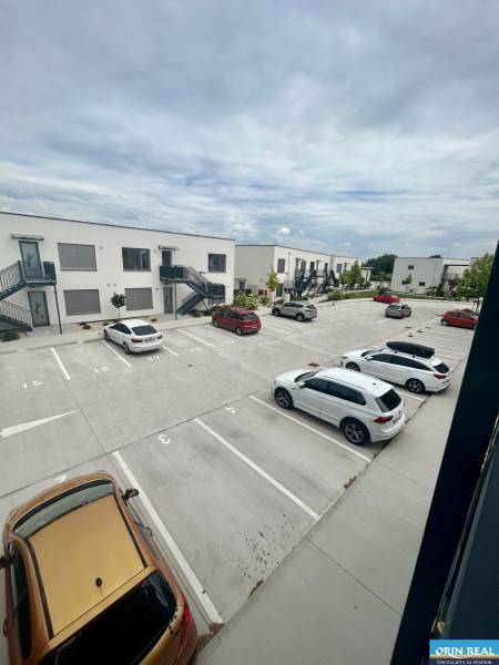 Parking lot on Golfová Street in Hrubá Borša in front of 2-room apartments, several cars parked.