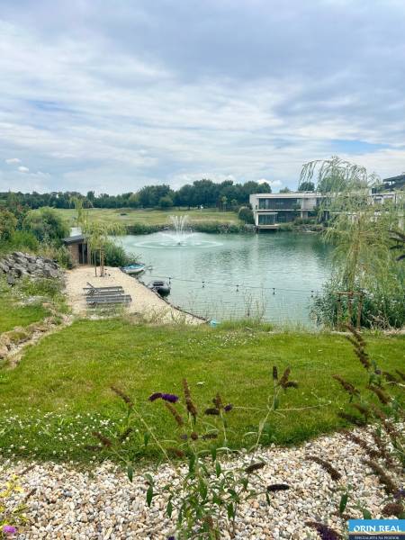 A lake with a fountain surrounded by nature in Hrubá Borša on Golfová Street near a 2-room apartment.