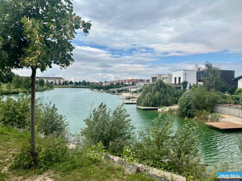 Lake with adjacent houses on Golf Street in Hrubá Borša in the picture.
